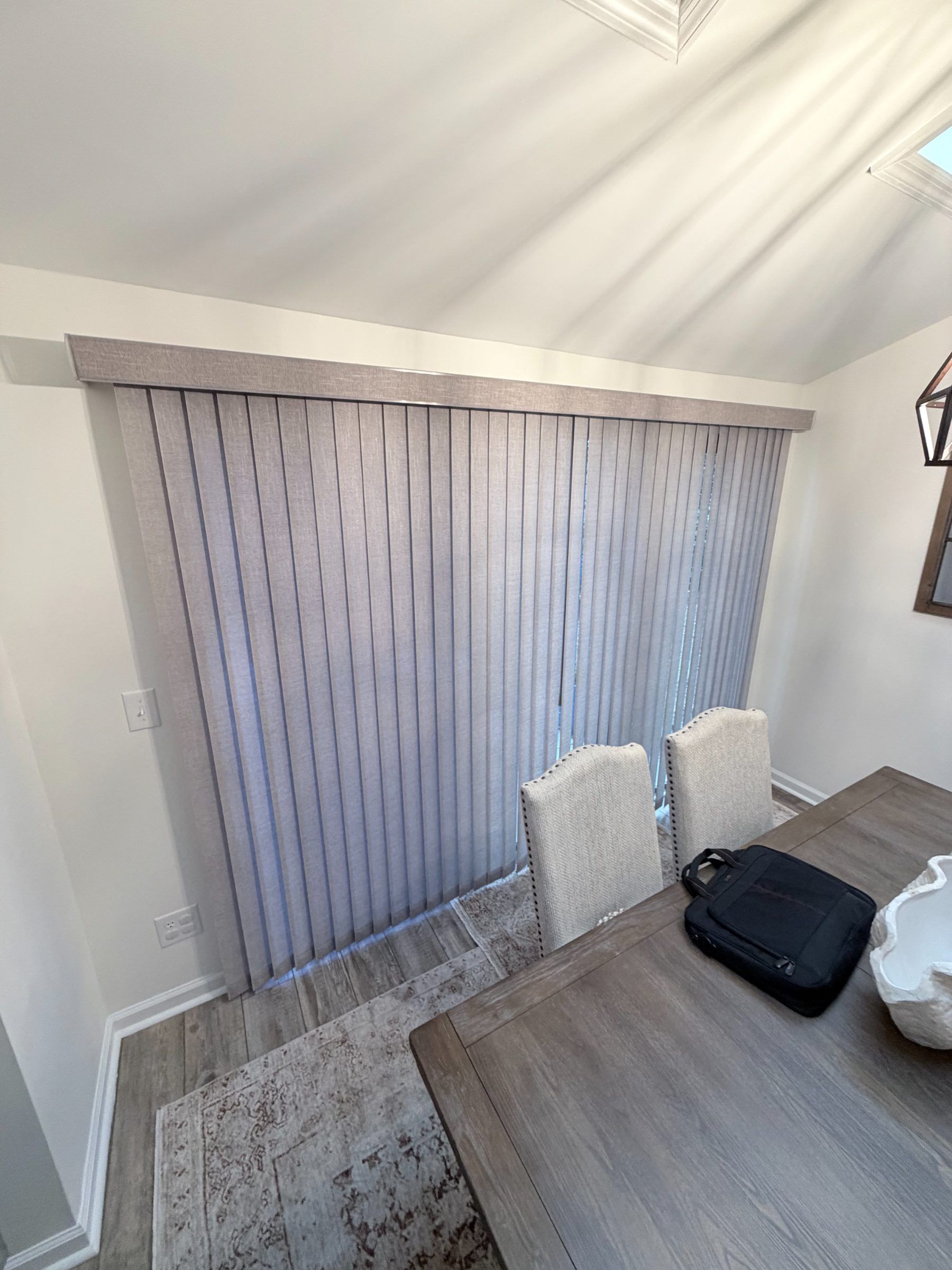 Grey Vertical Blinds Closed in a Dining Room