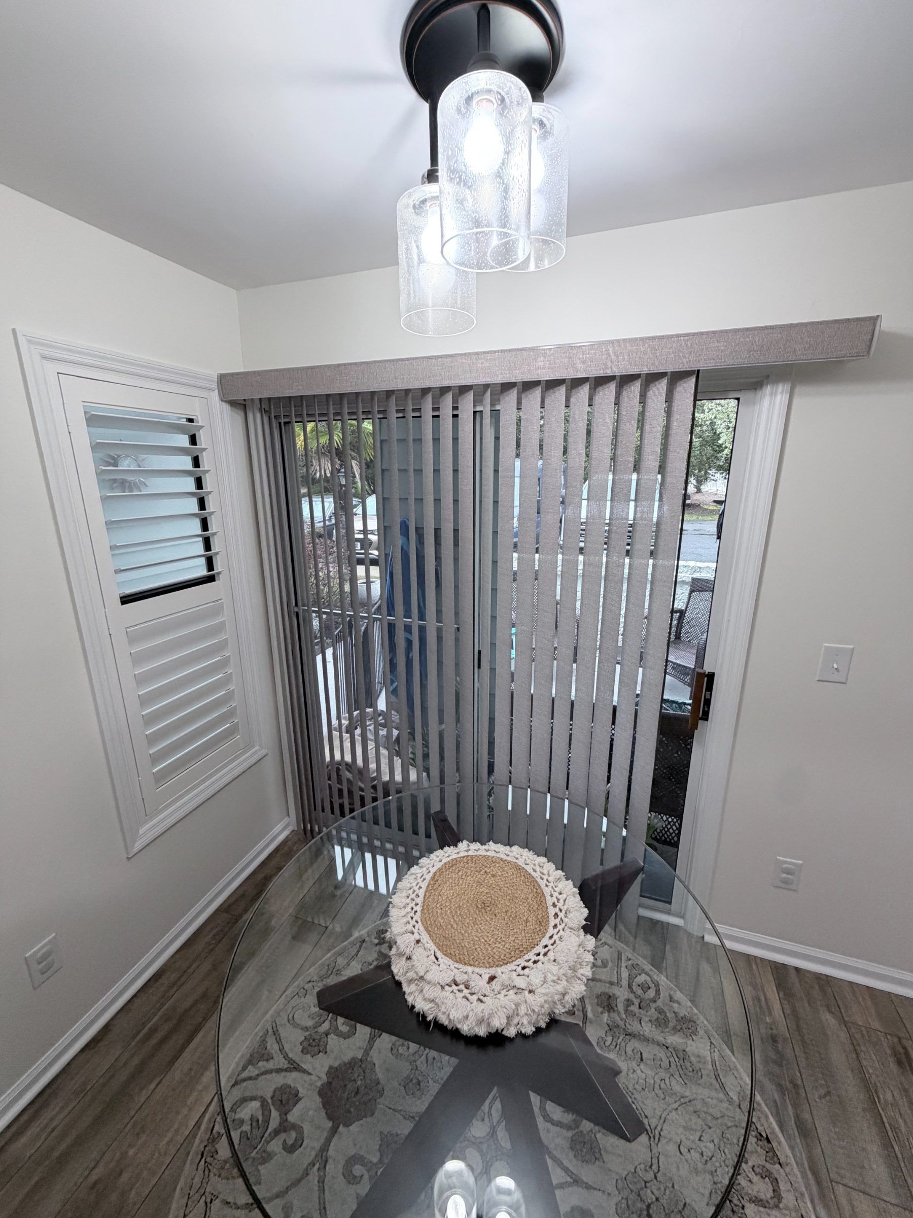Grey Vertical Blinds Partially Open in a Breakfast Nook