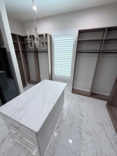 Split tilt plantation shutters over a window in a walk in closet in Loris, South Carolina