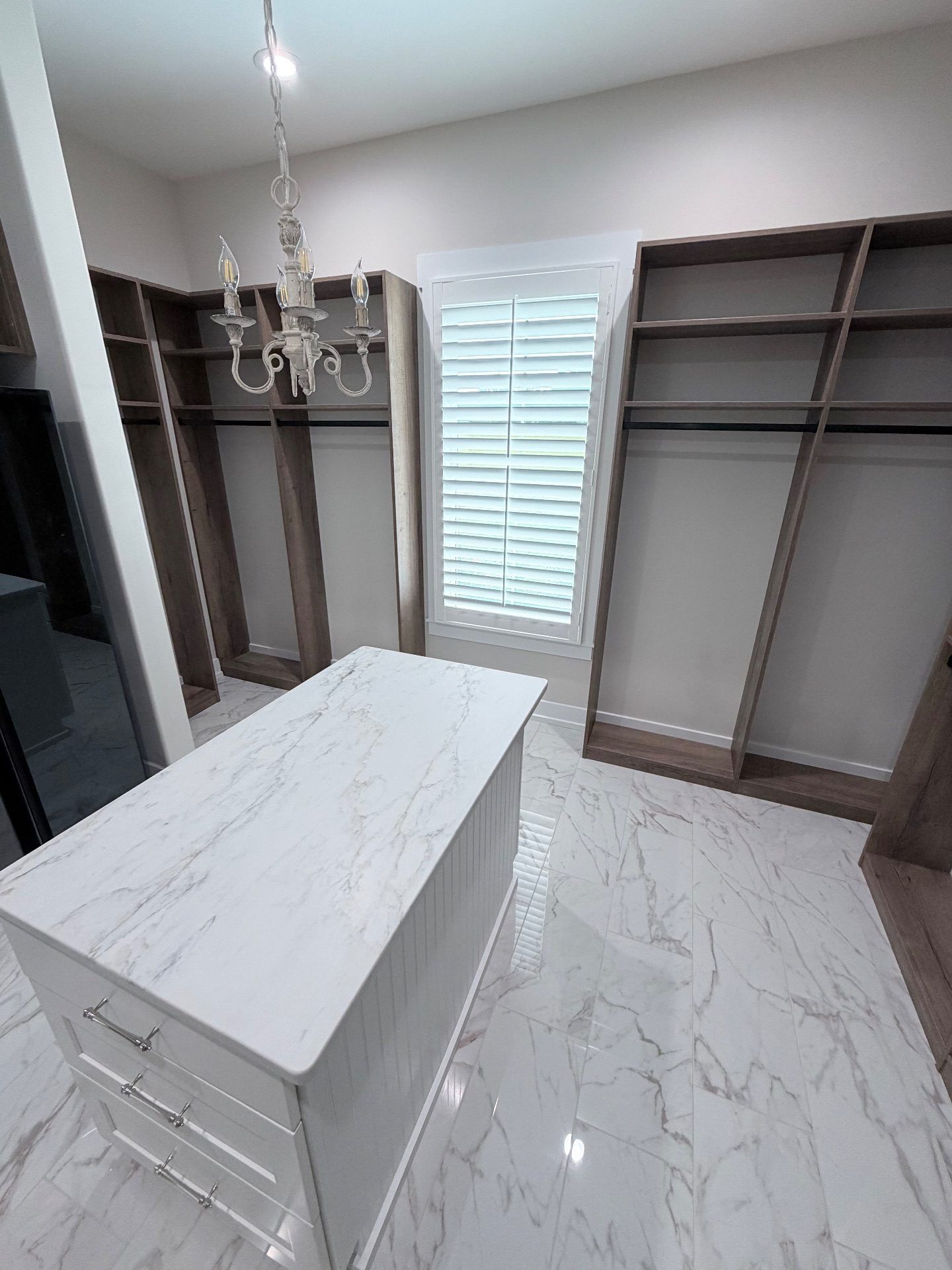 Split tilt plantation shutters over a window in a walk in closet in Loris, South Carolina