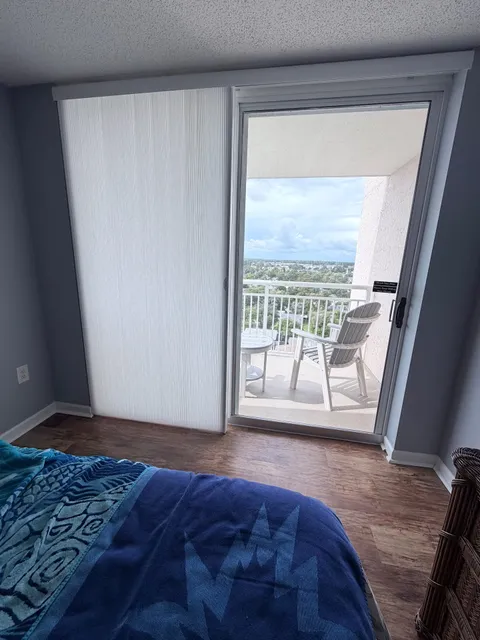 Applause Honeycomb Vertiglide over a Sliding Glass Door in a Condo (Shown open)