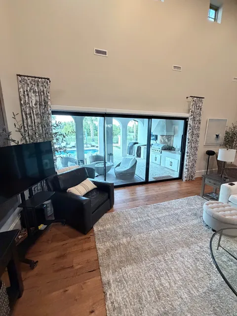 Large sliding glass door for a lanai with Roller Shades and Floral Blue Drapery Panels