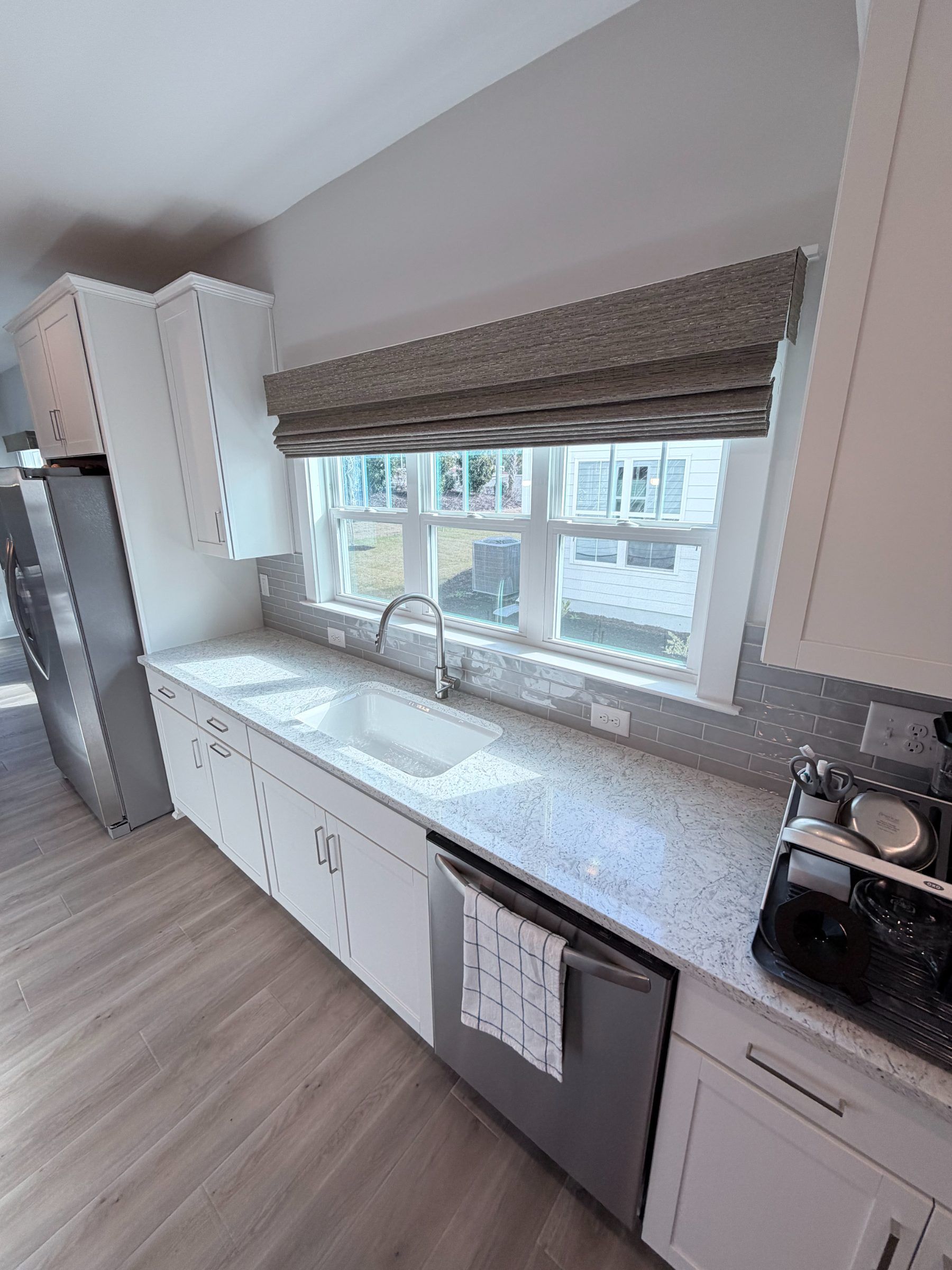 Hunter Douglas Provenance Woven Wood Shade over a Kitchen Sink