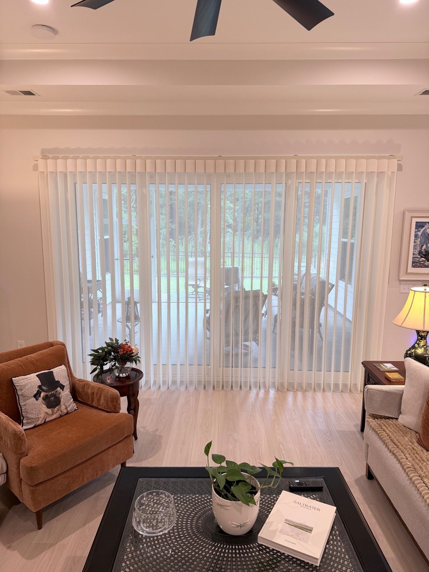 Smart Drape Fully Open over a large sliding glass door in a Living Room at Toll Brothers Ocean Isle Palms