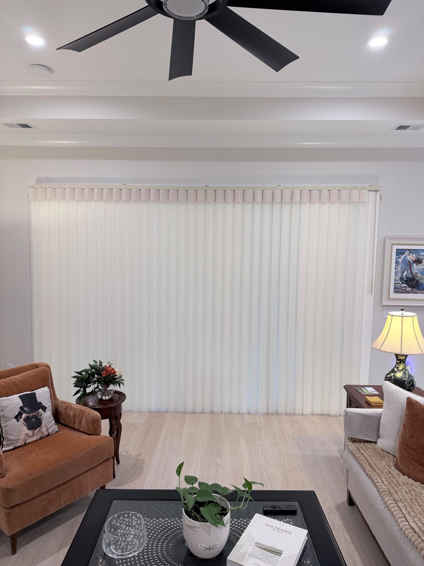 Smart Drape Fully Closed over a large sliding glass door in a Living Room at Toll Brothers Ocean Isle Palms