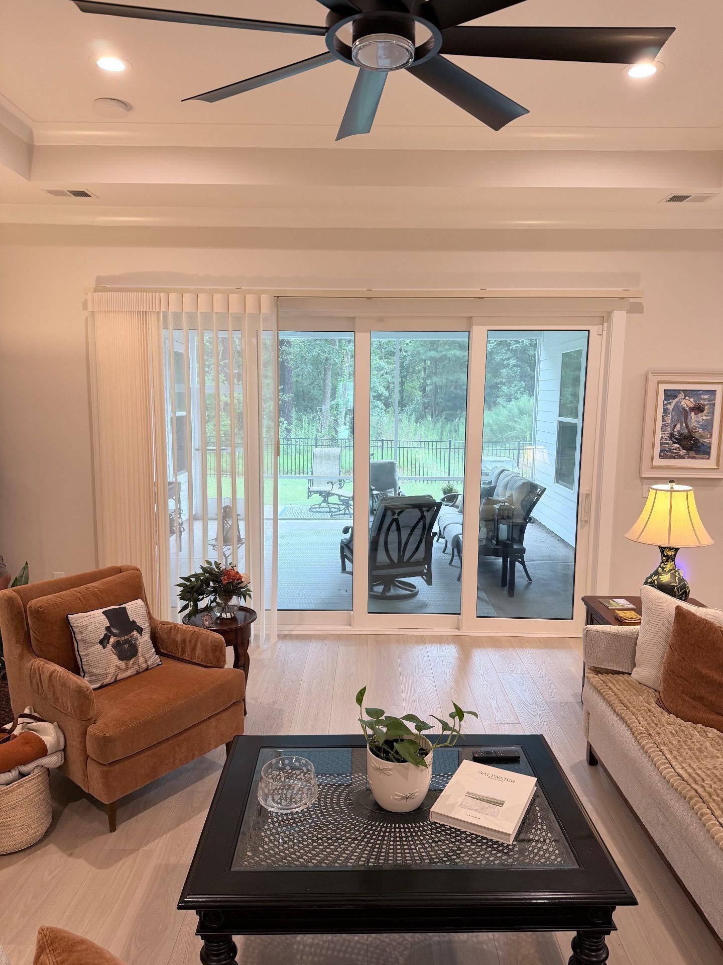 Smart Drape Partially deployed over a large sliding glass door in a Living Room at Toll Brothers Ocean Isle Palms