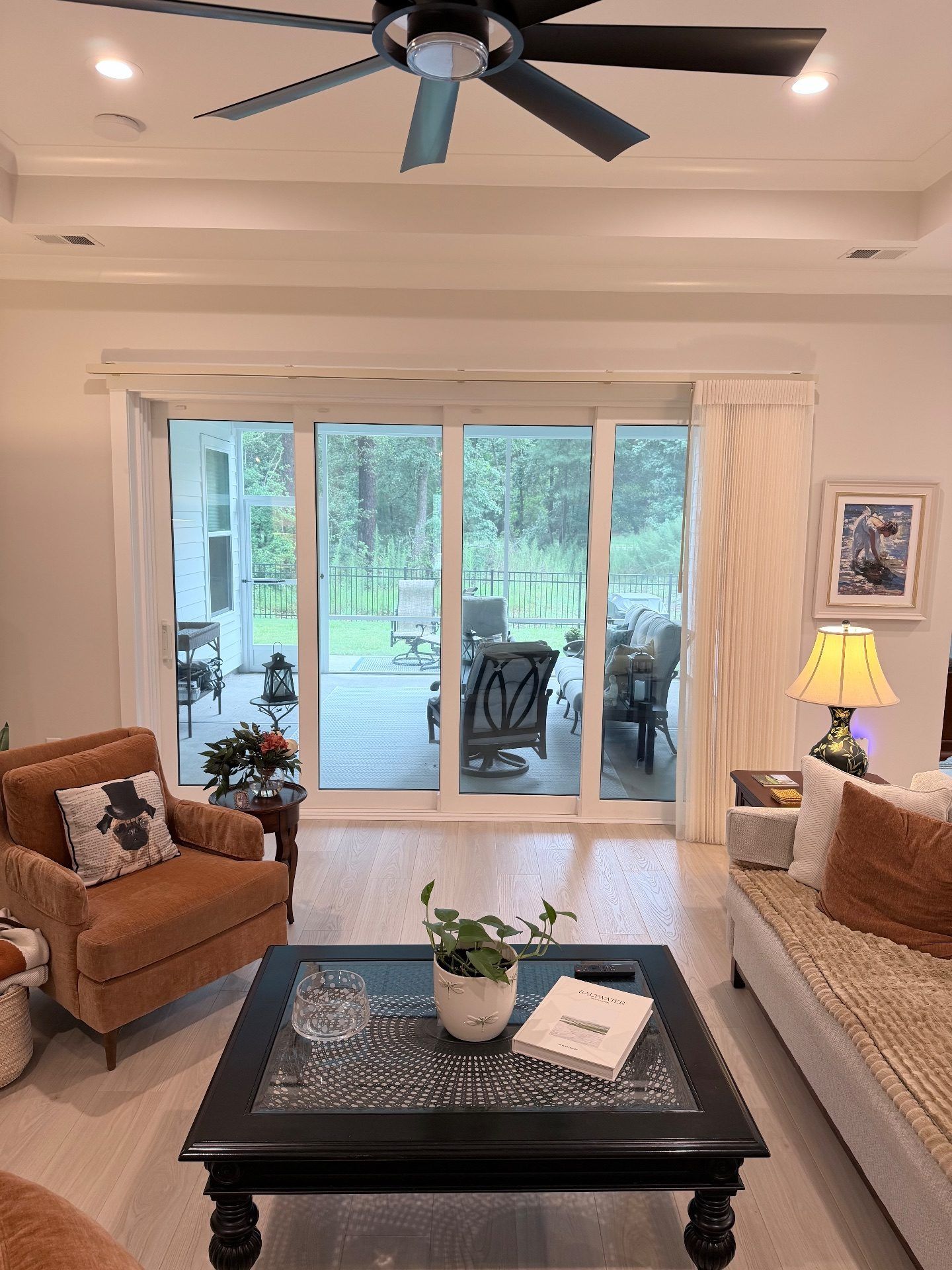 Smart Drape Stacked to the Right over a large sliding glass door in a Living Room at Toll Brothers Ocean Isle Palms
