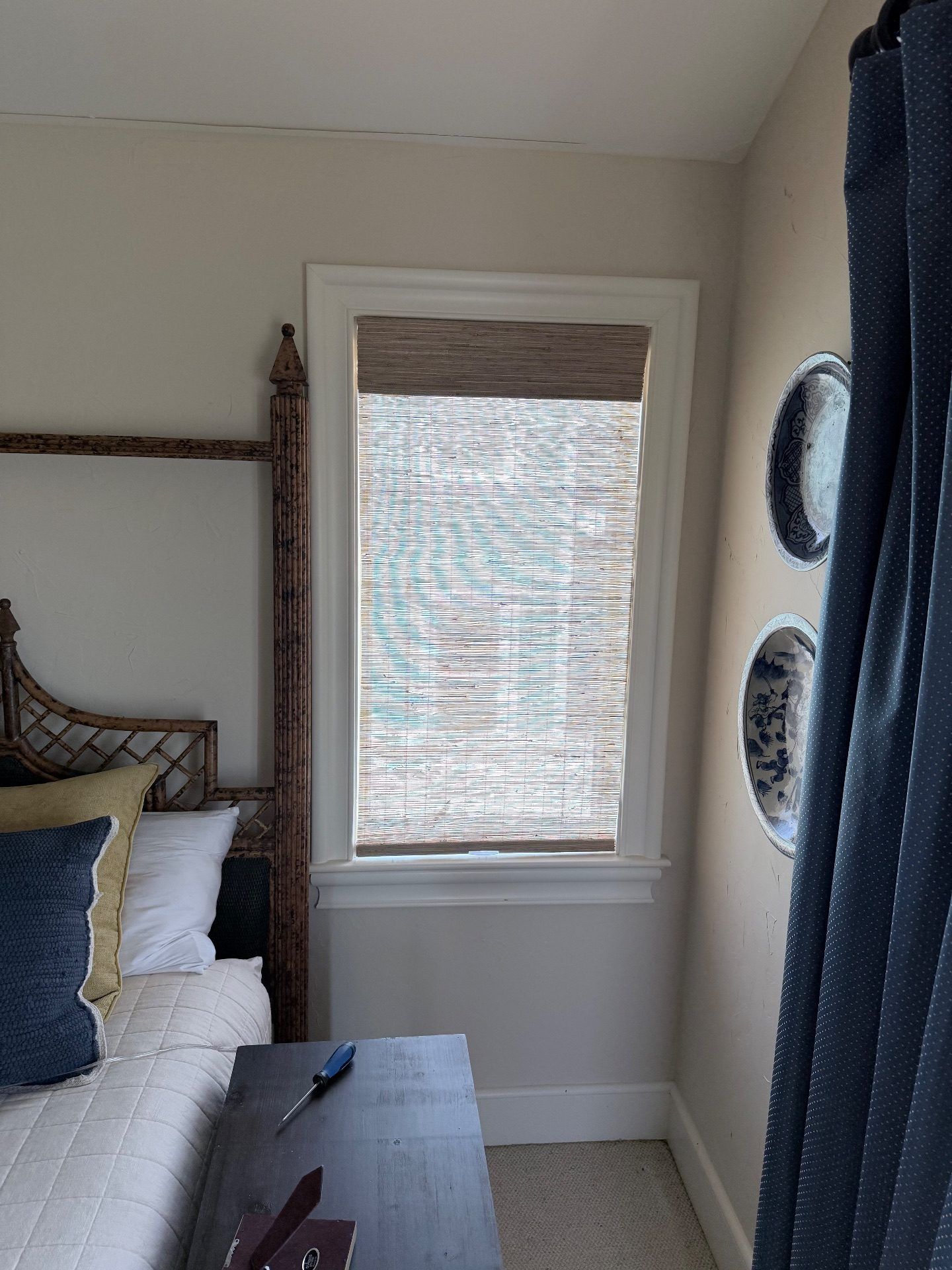 Brown woven wood shade in a bedroom