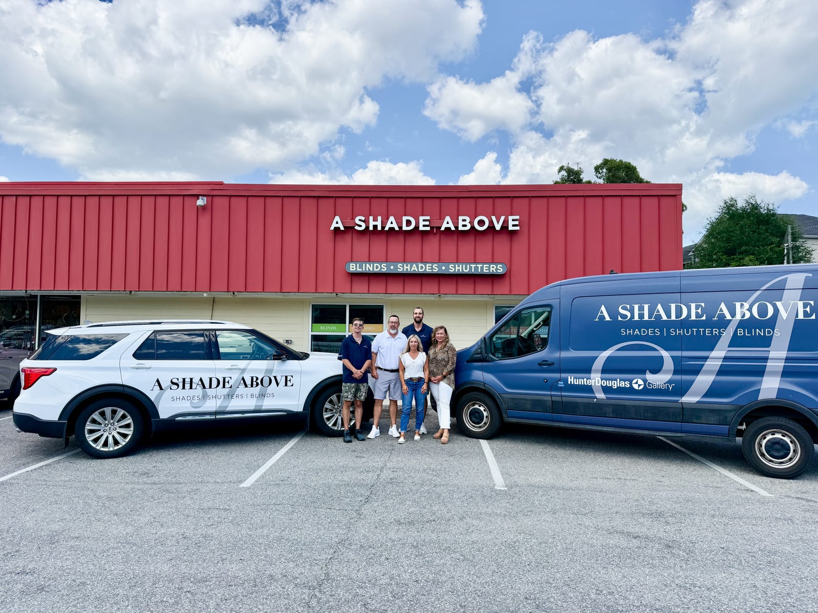 The Cherry Grove showroom: the red-roofed A Shade Above shop with the wrapped van parked out front.