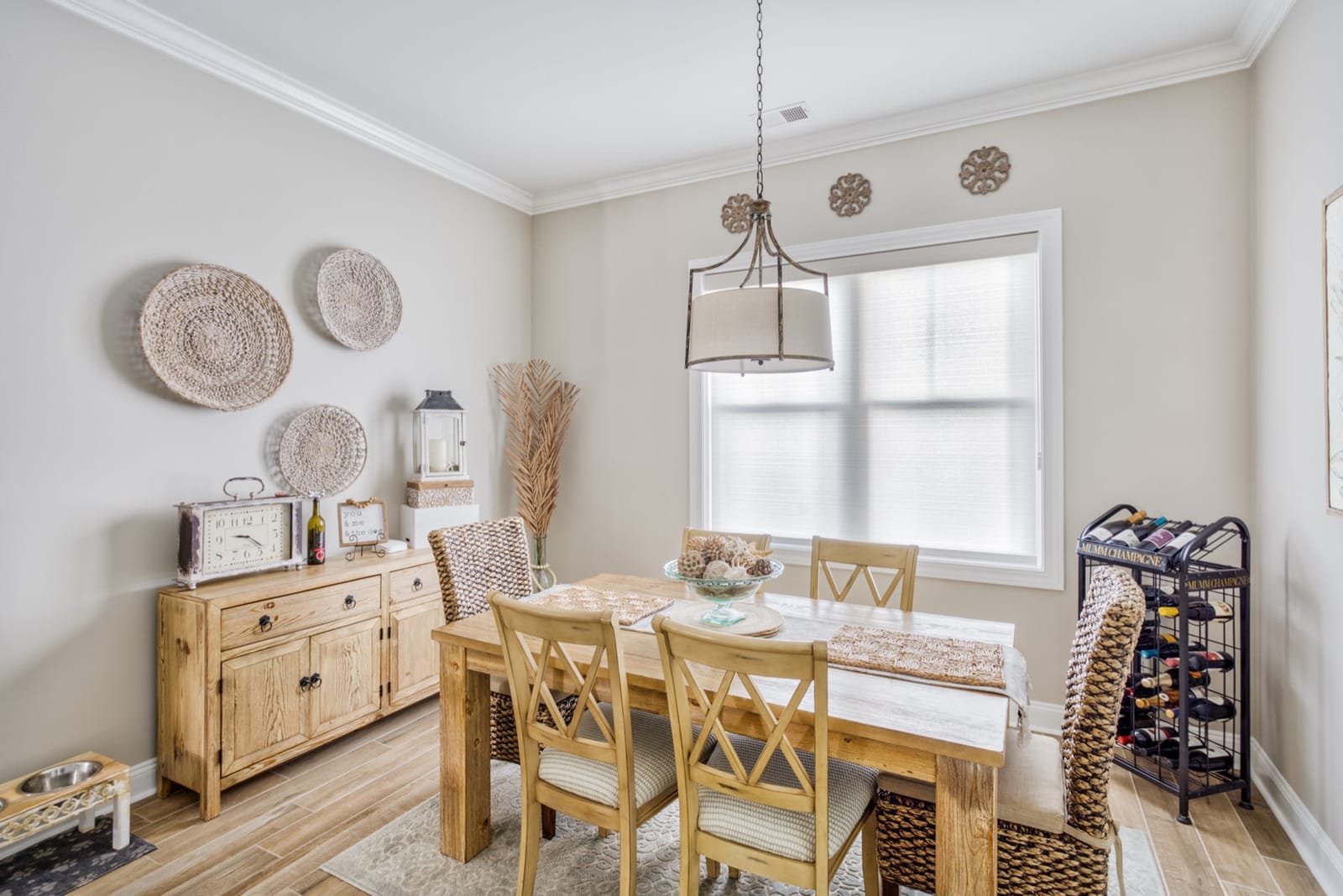Roller shades in a coastal dining room, installed by A Shade Above Coastal.