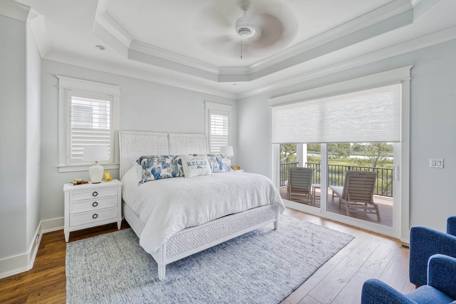 Plantation shutters in a coastal bedroom, installed by A Shade Above Coastal.