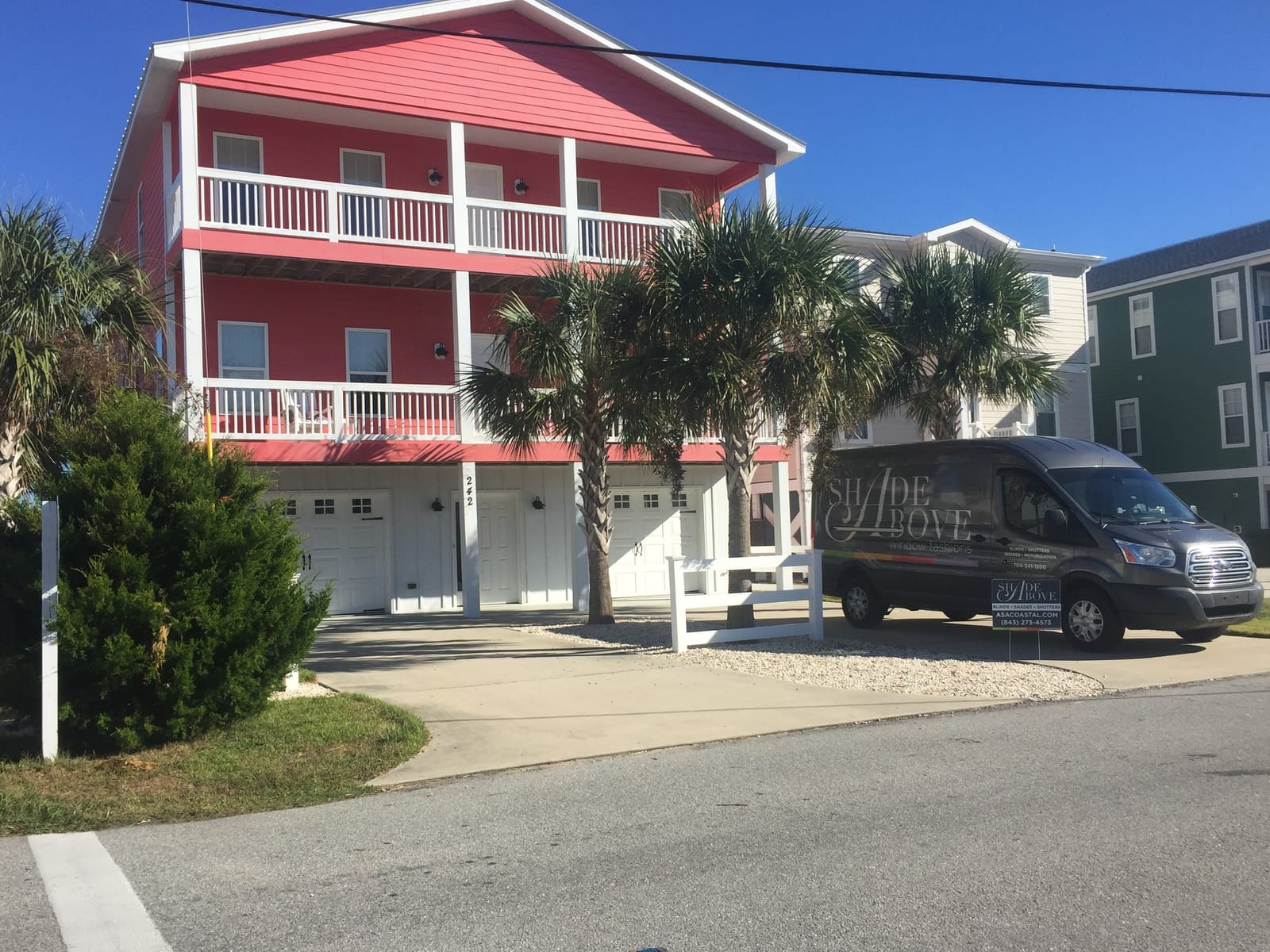 The A Shade Above Coastal van parked at a beach house.